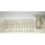 C20th glass water set, comprising baluster jug on star cut base H22cm and eighteen tumblers, H11cm