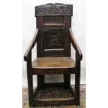 C17th oak Wainscot chair, C scroll top rail and leaf-carved panel back, downswept arms with