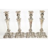 Set of four Victorian style EPNS candlesticks with urn sconces on tapering columns and shaped square