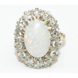 18ct yellow gold opal and diamond cluster ring, the large cabochon opal surrounded by fourteen