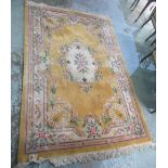 A late c20th Chinese embossed wash woollen rug, old gold ground, central floral pattern medallion,