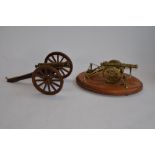 2 cast metal model cannons (non-firing), one on a base. Larger cannon size approx 28cm long x 18cm
