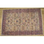 C20th Indo Persian wool rug with central fawn ground floral pattern centre and stylised floral