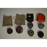 A collection of fishing equpiment including side arm reels, multipliers, centrepin reels, fishing