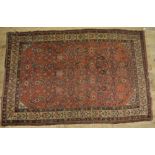 C20th Tabriz style wool rug, rust red ground, floral centre and beige ground repeating patterned