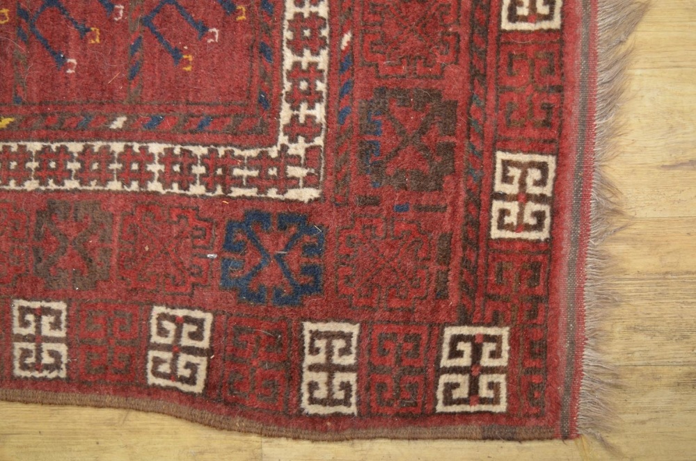 C20th Beshir style red ground wool rug, with patterned central field and geometric patterned border, - Image 2 of 3