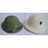 A 1960s era US Marines tropical Pith helmet with sweat band, no other markings, with USMC cap badge,