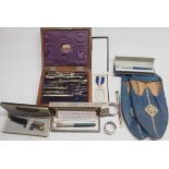 Three hallmarked silver napkin rings, early 20th century W.H. Harling mathematical instrument set in