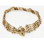 9ct yellow gold four bar gate bracelet with heart padlock clasp and safety chain, stamped 375, 13.6g