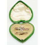 Victorian 9ct yellow gold horseshoe brooch set with red and clear stones, and another 9ct yellow