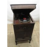 c1920s HMV type oak cased free standing wind-up gramophone, with panelled doors, lower section being