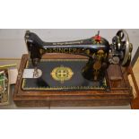 Singer sewing machine with unusual decoration in original wooden case, with instruction manual and