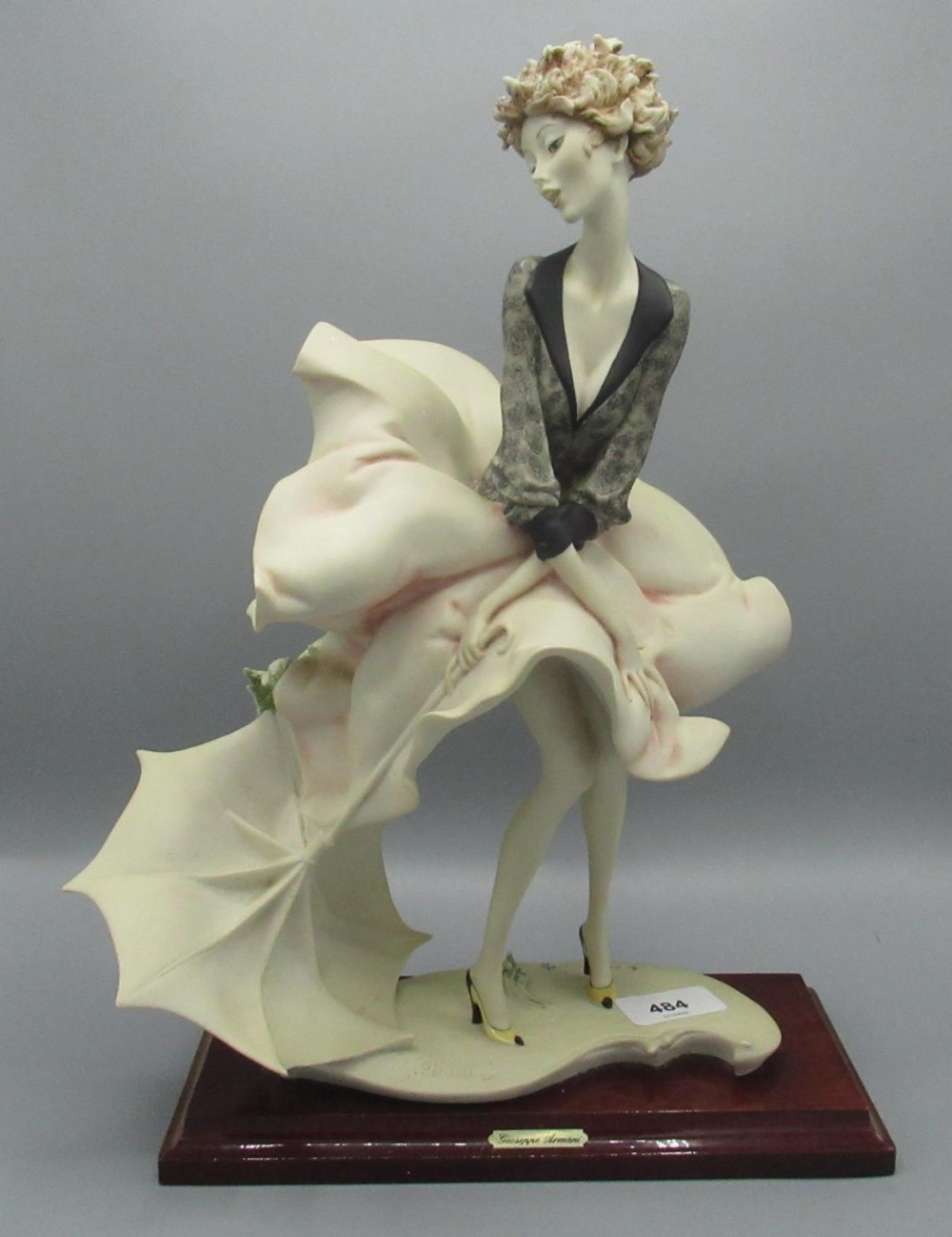 Florence/Giuseppe Armani figurine of a girl with umbrella, manufacturer's mark to the base, H37cm