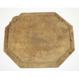 Robert Mouseman Thompson of Kilburn - an oak octagonal bread board, moulded edge carved with