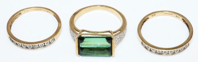 9ct yellow gold ring set with central emerald cut green stone, the shoulders set with diamonds,
