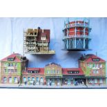 Quality diorama railway stations with figures, shops etc. A scaffolding repair to a mock Tudor house