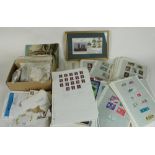 Large collection of mounted stamps on loose leafs with mixed loose used stamps and a Postmasters