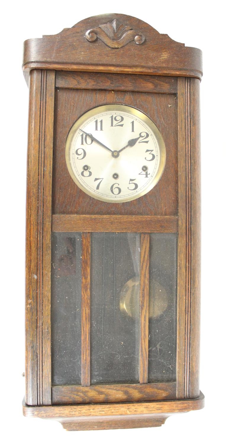 C20th oak cased wall clock, 6 1/2 inch silvered dial with arabic numerals and three wind up holes,