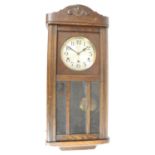 C20th oak cased wall clock, 6 1/2 inch silvered dial with arabic numerals and three wind up holes,