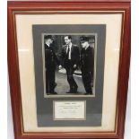 Framed Ronnie Biggs autograph with photo of him being led by two police officers (48cm W, 58cm H)