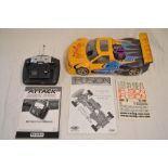 A Fusion Schumacher 1/10 scale nitro 4WD radio control car with instruction manual and a Futaba