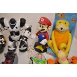 A collection of toys including 2 Buzz Lightyears and a Woody, an Iron Man and Bumblebee helmets,