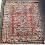 Property of a lady - an Afghan Kazak style woollen hand-knotted rug, with red ground, 90 by