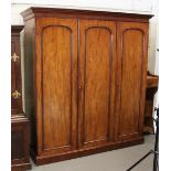 Property of a lady - a Victorian mahogany three door wardrobe enclosing slides & drawers, the