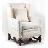 Property of a lady - a carved oak & cream coloured upholstered wing armchair.