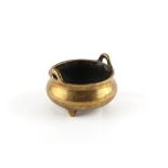 A Chinese bronze two-handled tripod censer of bombe form, 18th century, Xuande 6-character mark to