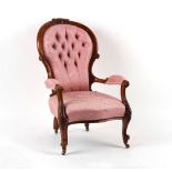 Property of a gentleman - a Victorian carved walnut armchair with buttoned patterned pink