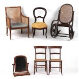 Property of a lady - an Edwardian mahogany & cane panelled bergere armchair, damage to seat