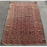 Property of a gentleman - a Turkoman carpet, with faded red ground, 136 by 90ins. (346 by 229cms.).