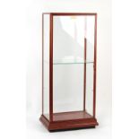 A vintage mahogany shop display cabinet, with hinged door, 26.75ins. (68cms.) wide (overall).