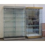 Two similar shop display cabinets, each with two sliding doors & glass shelves, 49.25 and 38.