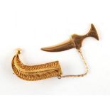 Property of a deceased estate - an unmarked yellow gold (tests 18-22ct) jambiya brooch, 45mm long,