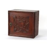 Property of a deceased estate - an 18th century oak spice cabinet, the geometric moulded door