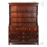 Property of a lady - a George III oak two-part dresser, with geometric moulded drawers & cupboard