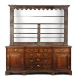 Property of a lady - a good late 18th century George III oak two-part dresser, the inverted breakfro