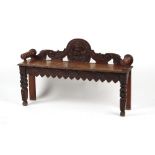 Property of a gentleman - a Victorian carved dark oak window seat, 48ins. (122cms.) long.