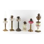 Property of a lady - six late 19th / early 20th century paraffin oil lamps, the tallest 26ins. (