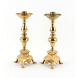 Property of a lady - a large pair of brass candlesticks, with triform bases, 16.2ins. (41cms.)