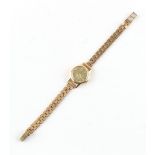 Property of a lady - a lady's Omega 18ct gold cased mechanical wristwatch on 9ct gold bracelet