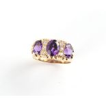 A 9ct gold amethyst & diamond ring, the three oval cut amethysts alternating with two rows of