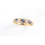 An early 20th century 18ct yellow gold sapphire & diamond five stone ring, size M.