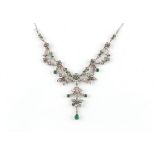 A fine Belle Epoque period emerald & diamond festoon necklace, the pear shaped & round cut emeralds