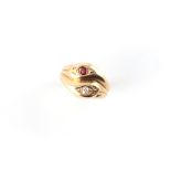 A 9ct yellow gold ruby & diamond twin snake head ring, approximately 4.7 grams, size N.