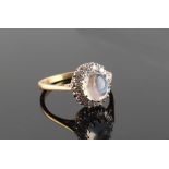 An 18ct yellow gold moonstone & diamond oval cluster ring, the oval moonstone measuring