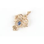 An Edwardian 9ct gold sapphire & seed pearl pendant brooch, the oval cut sapphire weighing