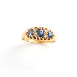 An Edwardian 18ct yellow gold sapphire & diamond ring, the three oval cushion cut sapphires